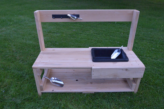 Infant mud kitchen made from natural cedar with a flexible rubber sink and lower storage shelf.