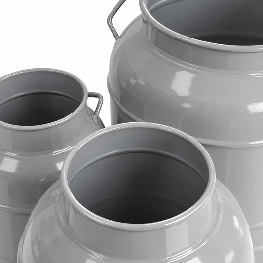 Close-up of three gray TTS metal churns showing their smooth coated metal finish
