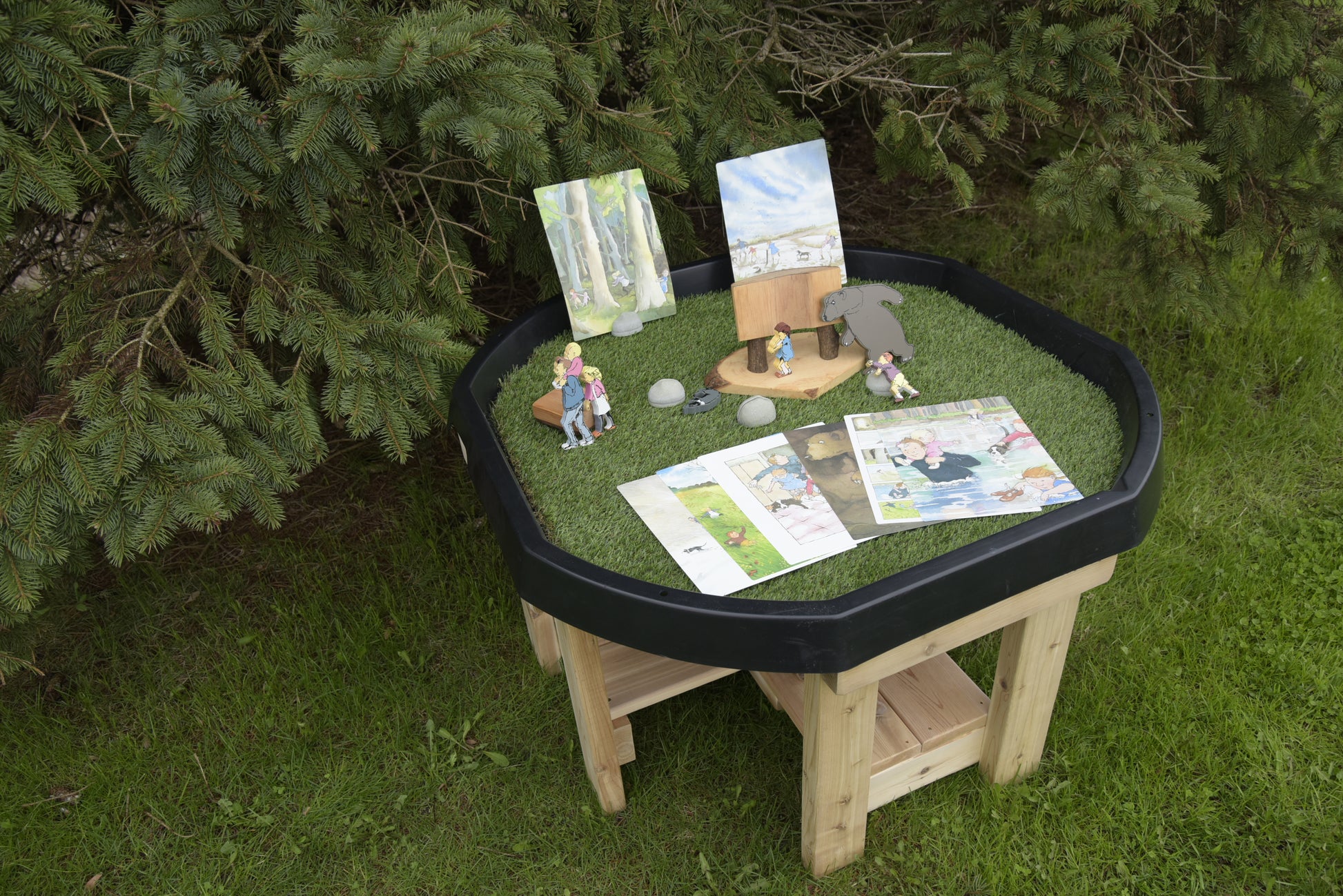 Cedar Active World Tray Stand holding a sensory TUFF tray in an outdoor preschool setting
