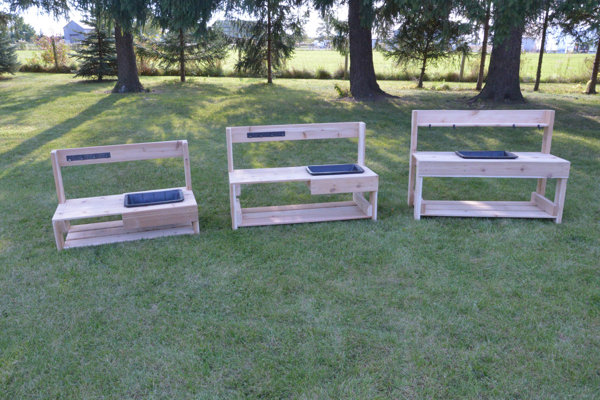 Three infant mud kitchens arranged outdoors for early childhood sensory play and exploration.