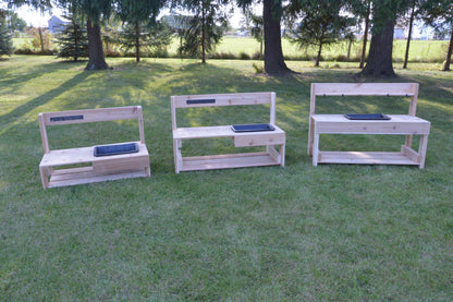 Three infant mud kitchens arranged outdoors for early childhood sensory play and exploration.