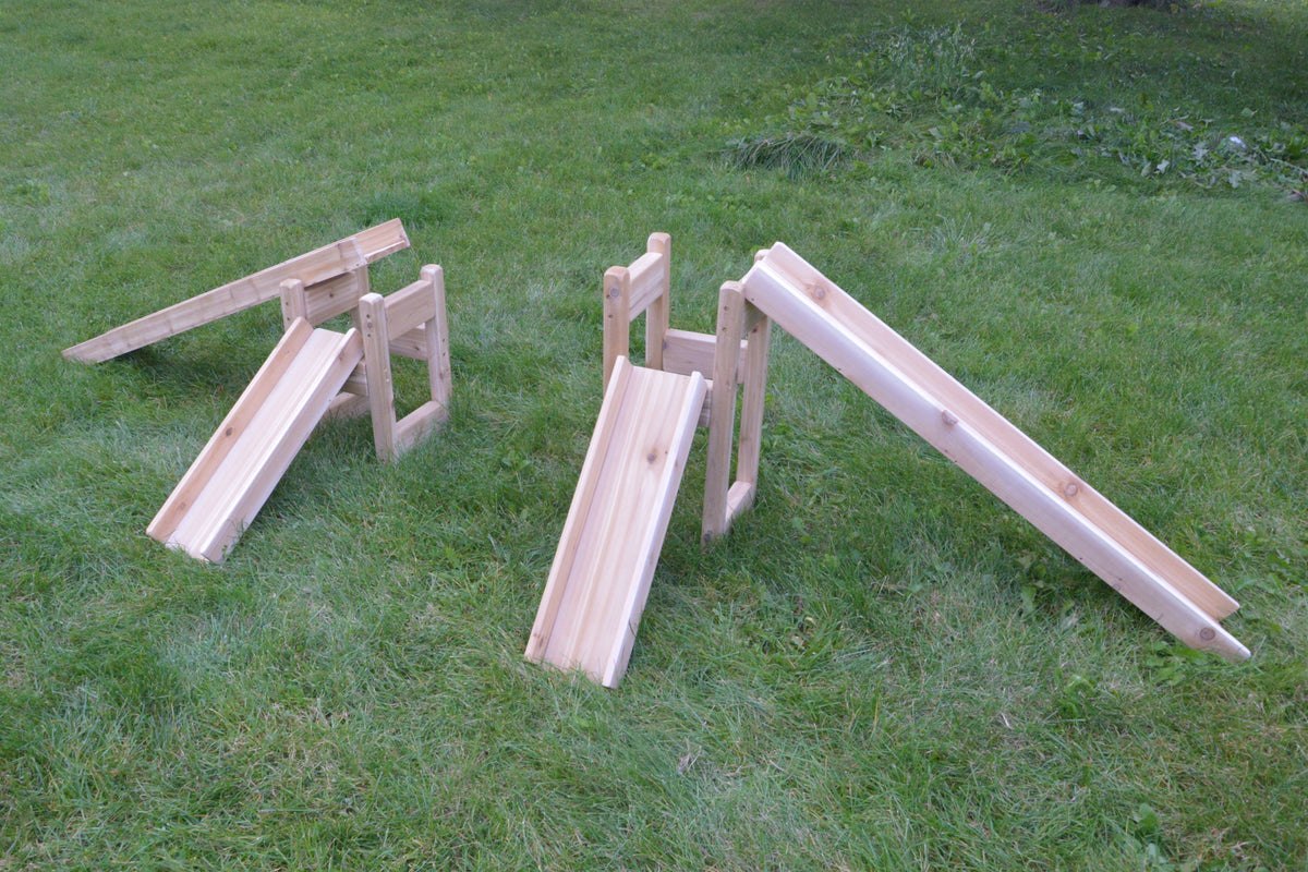 Natural wooden channelling system pieces arranged for outdoor water play