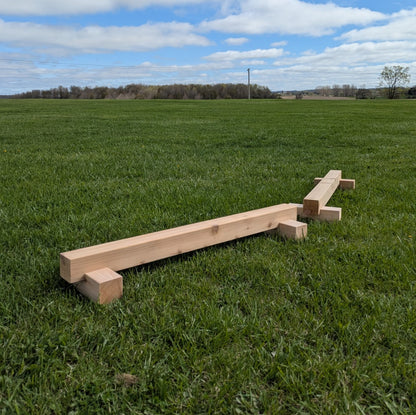Cedar balance beam arranged on grass for outdoor gross motor play