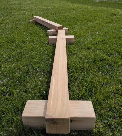 Outdoor cedar balance beam shown from above on grass